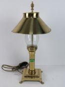A single brass table lamp having glass chimney and brass shade bearing label 'Orient Express Paris