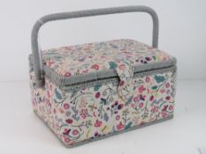 A sewing box covered in floral patterned fabric