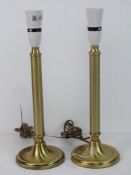 A pair of brass table lamps of column form.