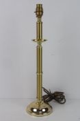 A single brass column table lamp.