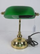 A 1/2 size brass 'bankers' lamp with green glass shade.