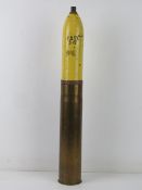 An inert WWII French 75mm HE re-painted shell with markings to the bottom of the casing.