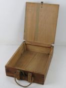 A WWII German 8cm wooden ammunition box, having stencilling on the box and rope strap.