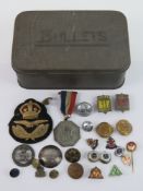 A quantity of assorted military badges, buttons, patches etc.