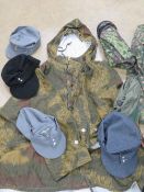 A quantity of assorted reproduction WWII German military items; clothing, caps, hats,