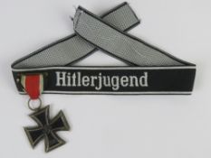 A WWII German Iron Cross 2nd Class with a Hitlerjugend Cuff title.