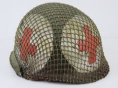US Medical Vietnam era helmet with chin strap and with medical cross painted all sides of the