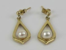A pair of 9ct gold and pearl earrings, hallmarked 375, with butterfly backs, approx 2.5cm drop, 1.