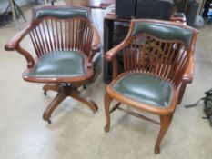 A green leather swivel chair raised over replacement castors with tilt function.