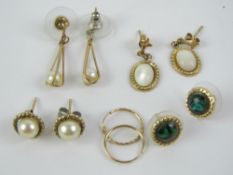 A quantity of yellow metal earrings, all pairs, two set with pearls.