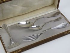 A German silver Christening set in original fitted box comprising fork, spoon, teaspoon and pusher,