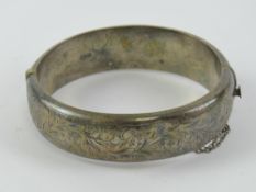 A HM silver hinged bangle having floral engraved decoration, hallmarked for chester, 6.2 x 5.