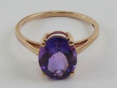An amethyst cocktail ring, stamped 10k with 9ct gold hallmark, oval cut stone approx 2.87ct (11 x 8.
