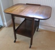 A c1950s drop leaf wheeled tea trolley with undershelf, 64