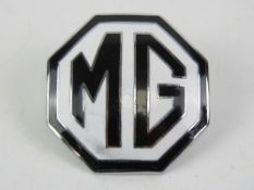 A vintage enamel MG car badge.