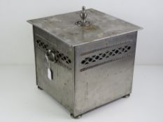 .A chromed square shaped log or coal bin.