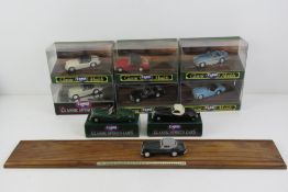 A set of five Corgi Classic Models sports cars with wooden stand, boxed.
