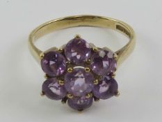 A 9ct gold and amethyst large floral cluster cocktail ring, hallmarked 375, size P, 3.15g.