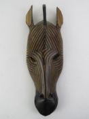 A carved wood and handpainted decorative wall mask in the form of a Zebra, approx 38cm in length.