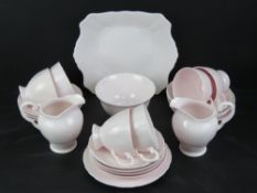 A blush pink tea set by Tuscan comprising jugs, milk, sandwich plate and trios.