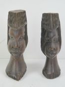 A pair of wooden carvings being male and female bust, each approx 17cm high.