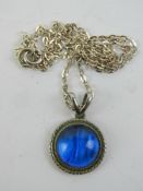 A vintage Art Deco butterfly wing pendant on silver chain.