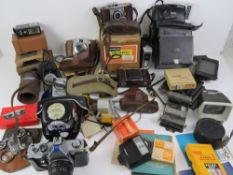 A large quantity of assorted vintage cameras and camera equipment,