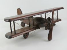 A vintage wooden model of an aeroplane, 50cm wide.