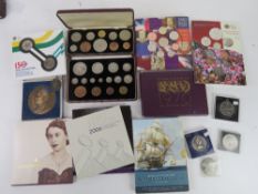 A quantity of commemorative coins and proof coin sets.