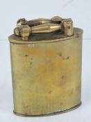 An early 20th century French table lighter in brass, cotton wick exposed by lifting up a lever,