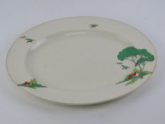 An Art Deco meat plate having Clarice Cliff Bizarre style pattern featuring trees houses and
