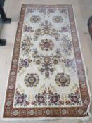 A cream ground rug measuring 164 x 82cm.