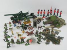 A quantity of Britains model toys including metal military artillery items and horse,