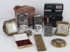 A quantity of assorted collectables including travel clocks, a cloisonné pill box, Polaroid camera,