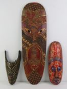 Three contemporary hand painted decorative wall masks,