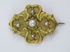 A Victorian yellow metal brooch set with split pearl and seed pearls, 3.3cm wide, 3.7g.