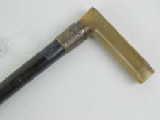 A 19th century ebonised walking cane having silver collar hallmarked for Chester and a horn handle,