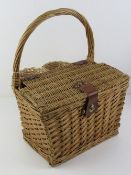 A wicker picnic basket / hamper having twin bottle holders and loop handle over, 32cm wide.
