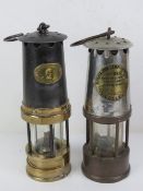 Two decorative Miners lamps 'Patterson Lamps Ltd' and 'Protector Lamp & Lighting Co Ltd Eccles',