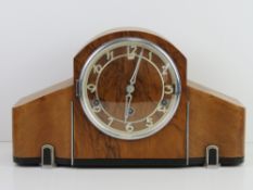 An Art Deco walnut and bakelite mantle clock.