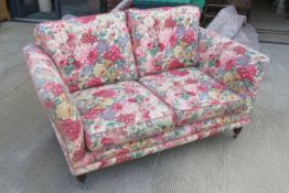 A chintz floral two seater settee 154 x 92cm.