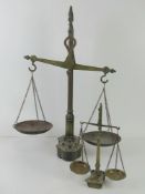 Two pairs of Victorian brass balance scales with weights.