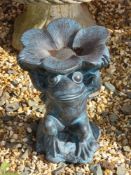 A resin frog garden ornament holding flower overhead, 30cm high.