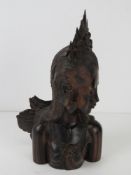 A Balinese carved wooden figurine of a goddess, 21cm high.
