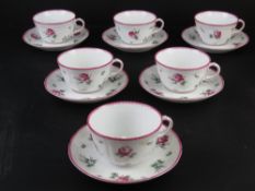 A set of six Richard Ginori cups and saucers in white ground with pink rose pattern upon.