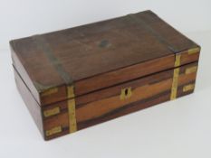 A writing slope having brass banding, opening to reveal black leather writing surface, a/f,