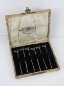 A set of six HM silver cocktail sticks having cockerel terminals within original Reed and Sons
