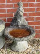 A pre-cast stone low birdbath, 67cm high.