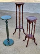 A pair of graduated planter stands having barleytwist supports united by an undershelf,