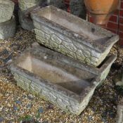 A set of three pre-cast stone planters having brickwork pattern upon, 66cm wide.